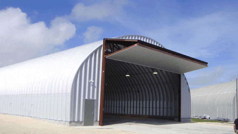 large quonset hut hangar at OPBAT base with bifold door raised