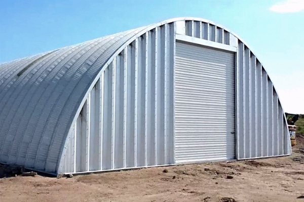 steel quonset hut storage building with white garage door