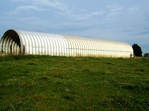 long steel quonset hut building with open ends