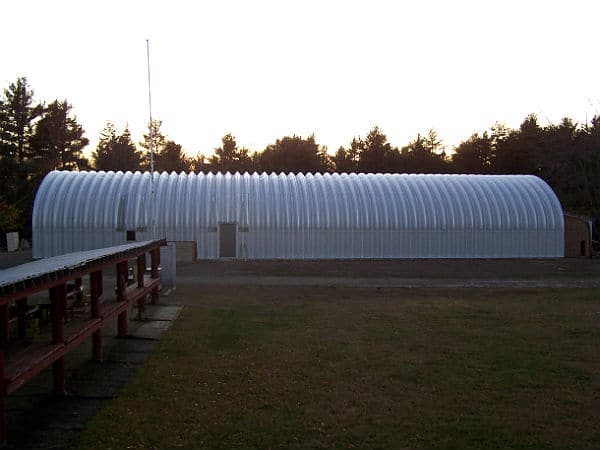 long s model steel quonset hut with side door opening