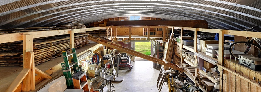 side quonset hut loft with wooden shelving
