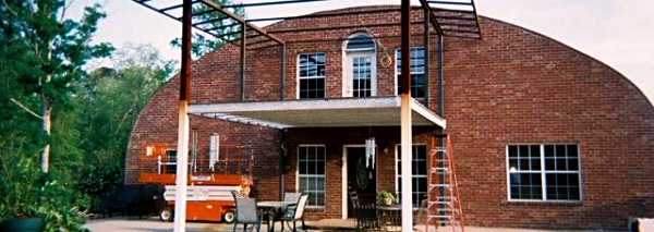 steel quonset hut with brick custom endwall and porch