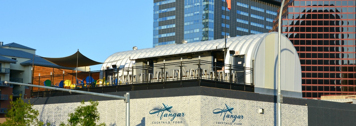 city with skyscrapers and quonset hut turned into rooftop bar