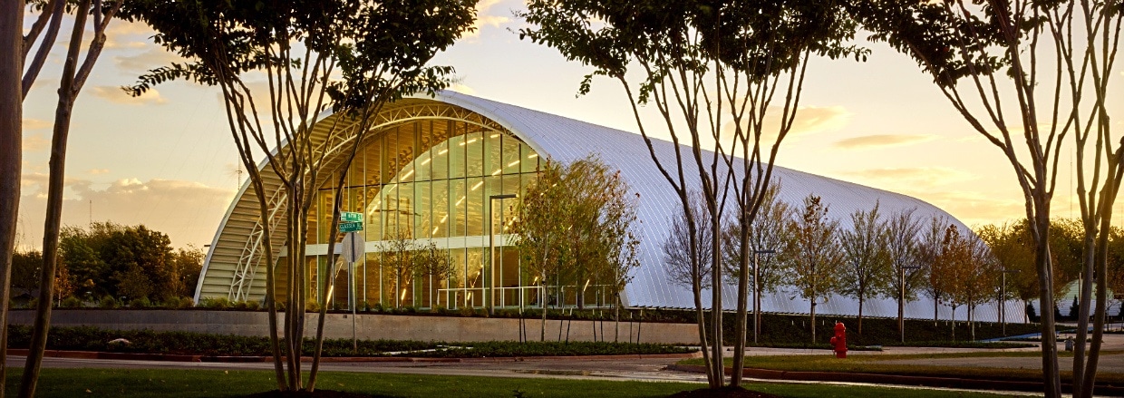 large steel building at dusk with glass window custom front endwall