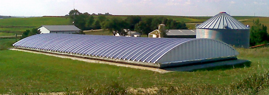 large steel building with concrete walls and ground around it