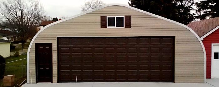 a model steel building with custom tan siding endwall with matching garage and walk thru brown doors in Pennsylvania