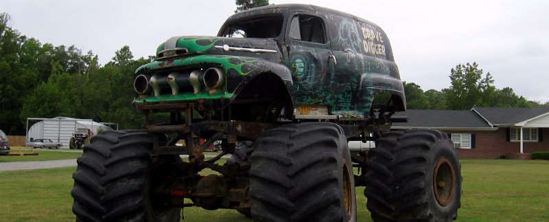 Grave Digger monster truck with steel building in background