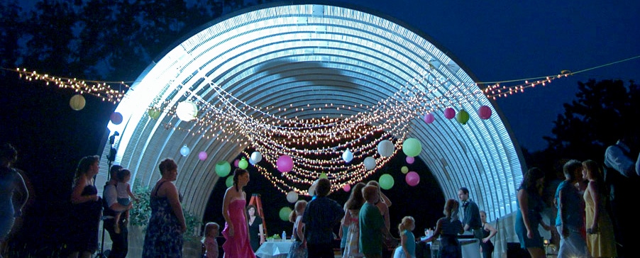 night time wedding reception under steel Quonset Hut