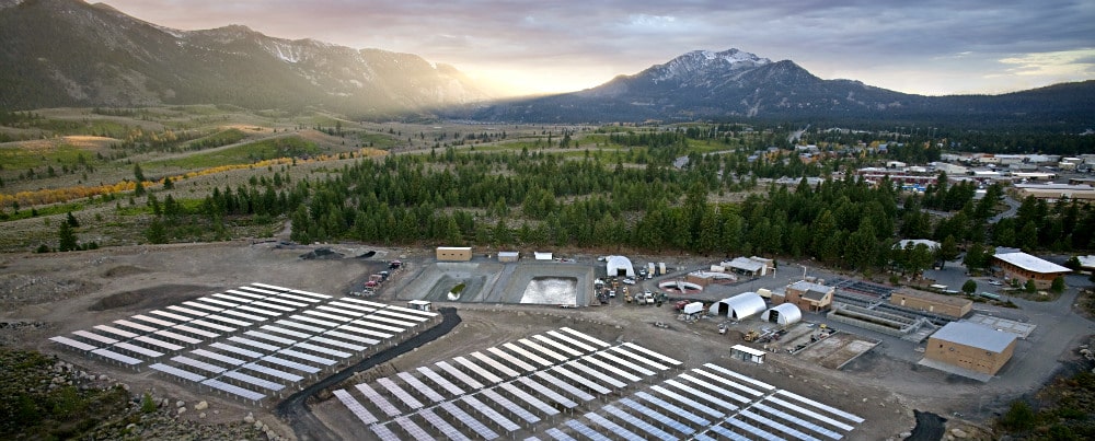 aerial view of industrial area with solar panels and quonset hut buildings