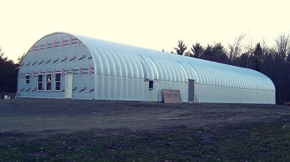 long quonset hut with side door opening and custom front endwall mid-construction