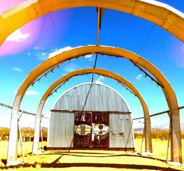art installation with vintage looking quonset hut and arches