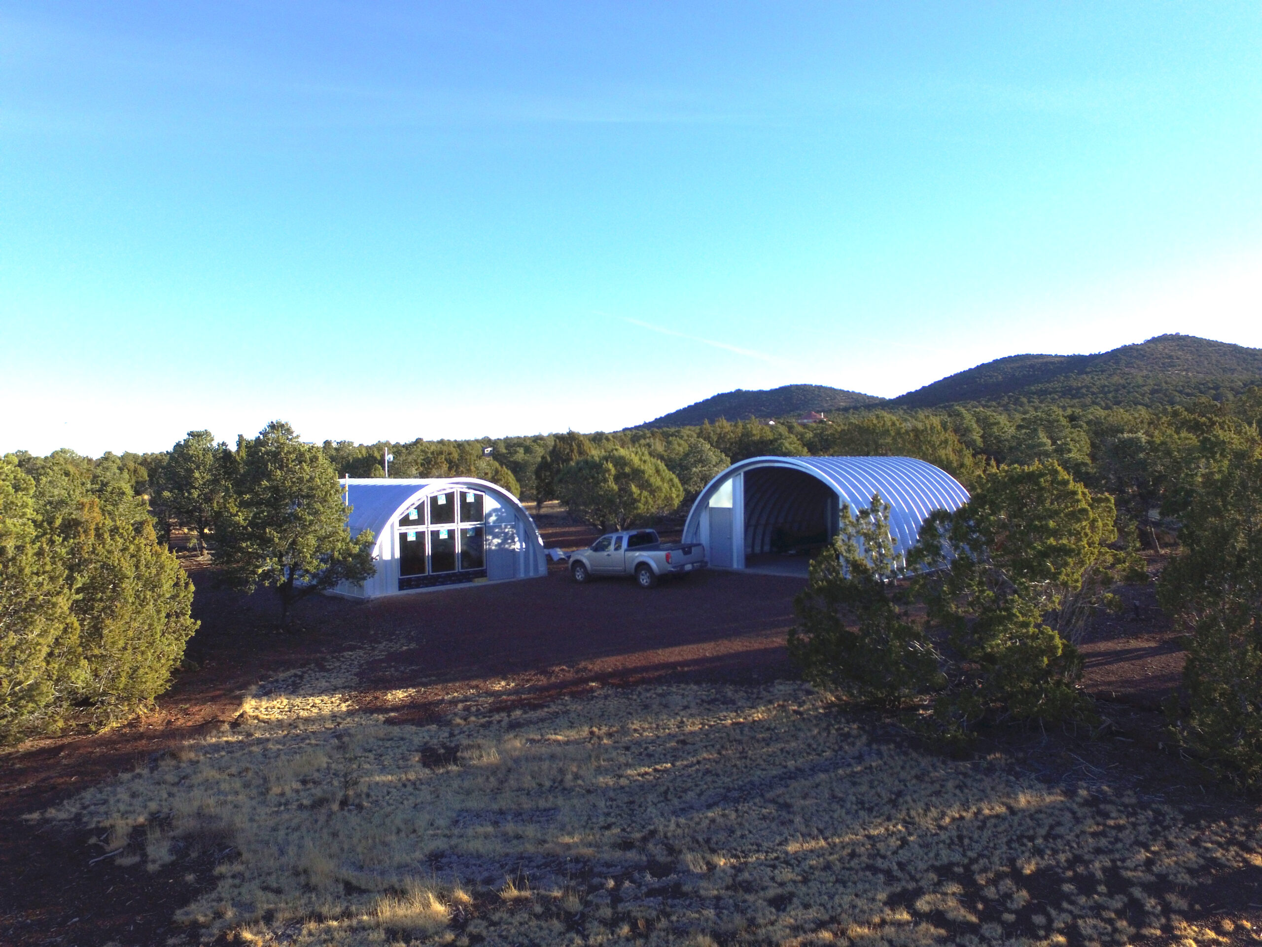 Q-Model home and Q-Model garage with mountains in the distance 