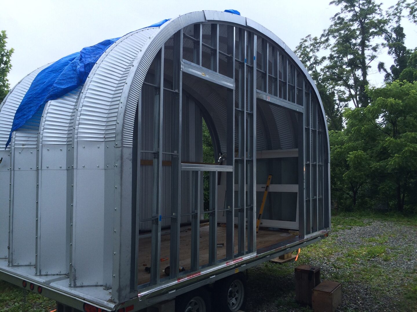 small quonset hut home mid construction with endwall framed