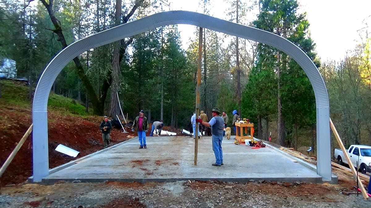 working site with open-ended quonset hut mid-construction