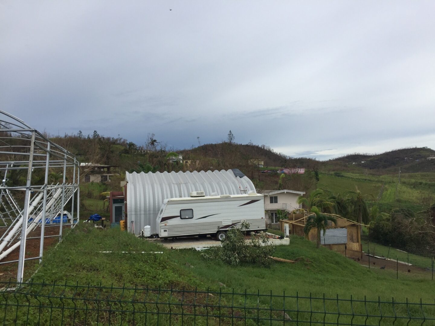 side view of steel quonset hut with rv next to it