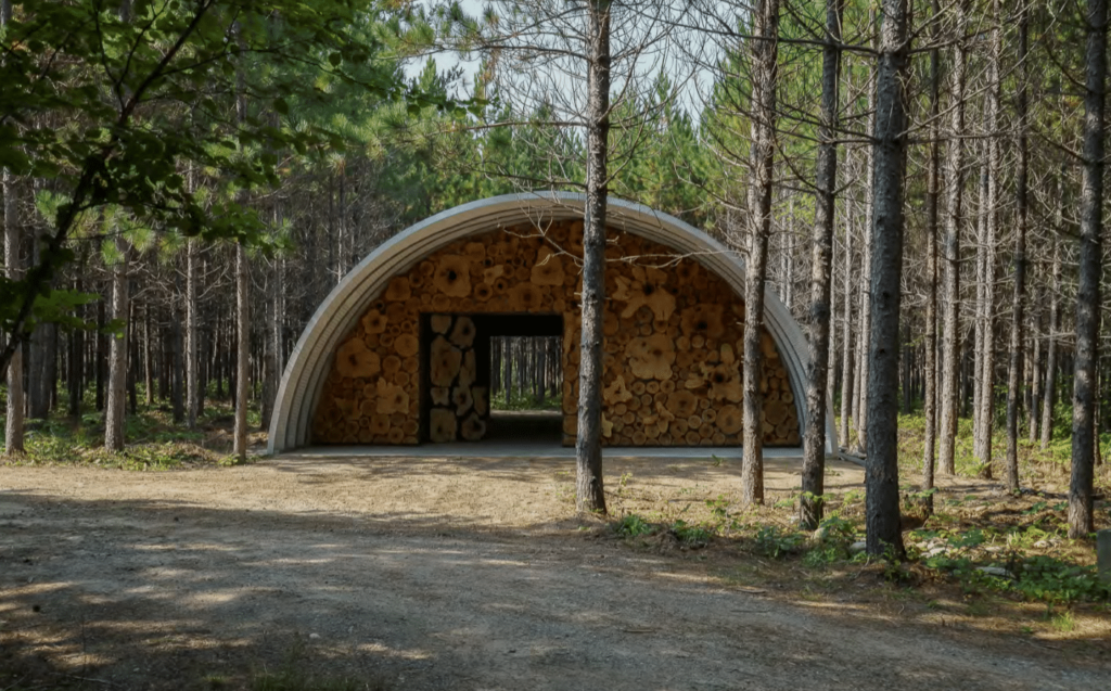 SteelMaster metal Quonset Hut with cedar endwalls in woods of Togo, Minnesota.