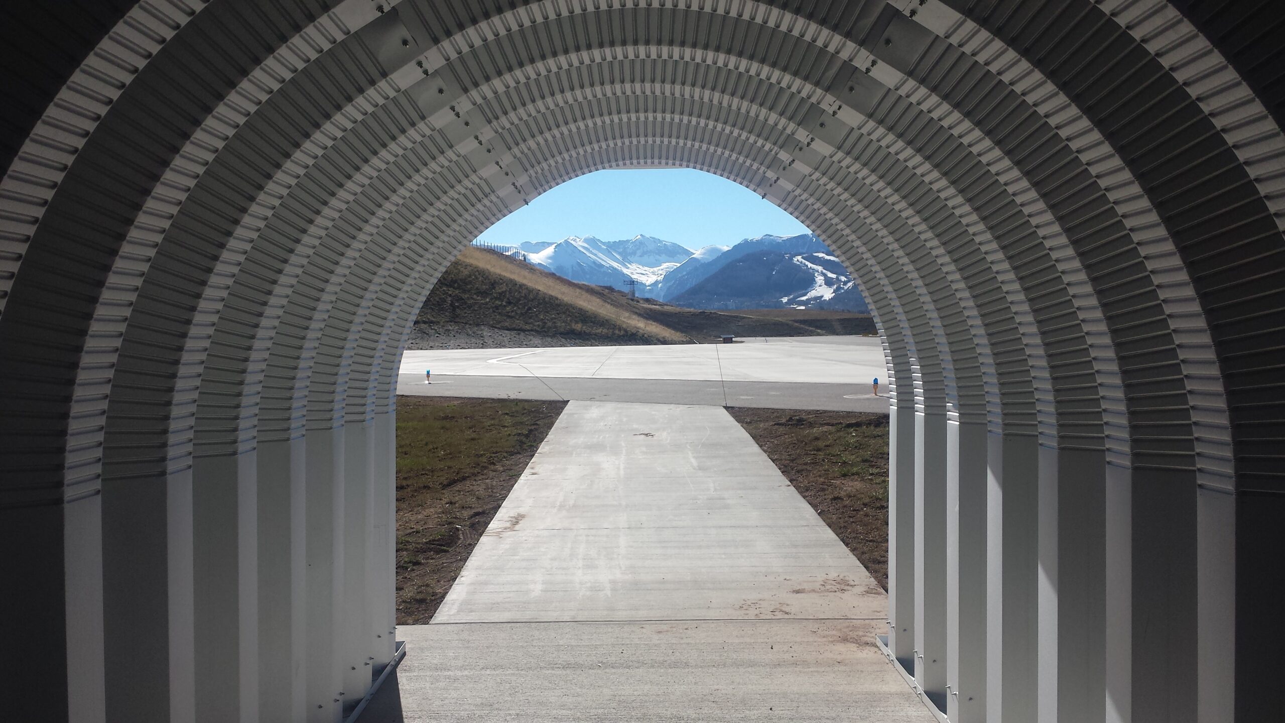 view from inside steel quonset hut of colorado mountains
