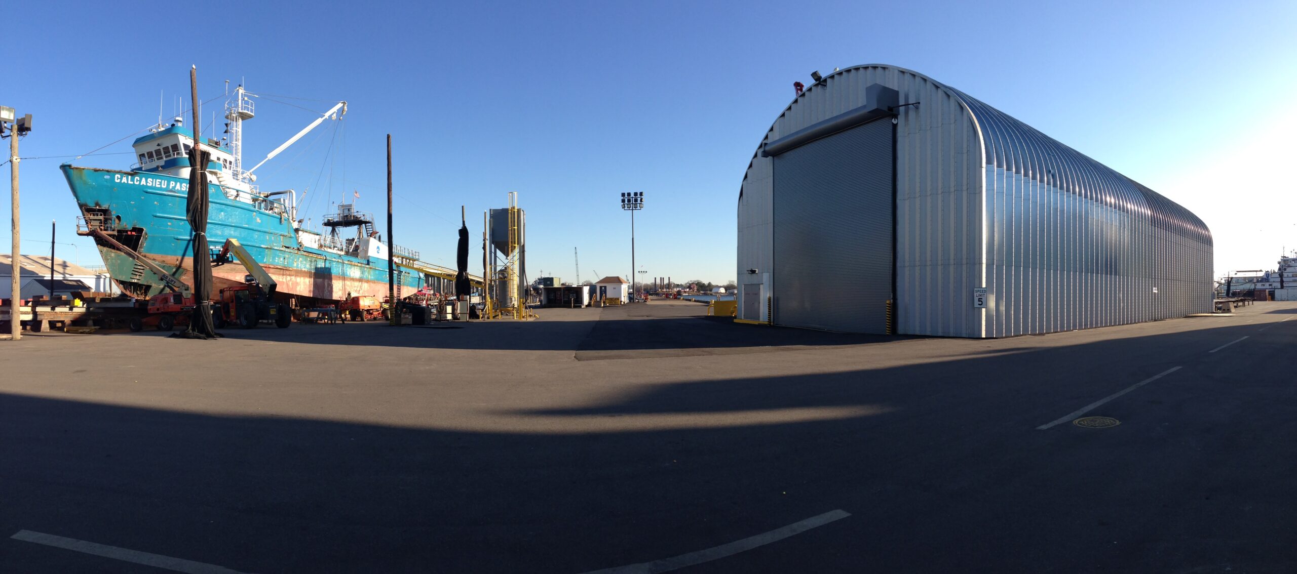 s model steel industrial storage building with large garage door and steel endwall at shipyard