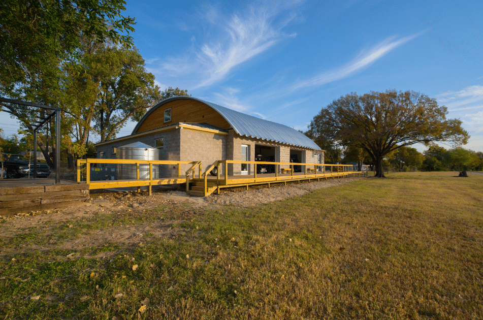 brick building on platform with side openings and steel arch roof