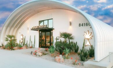 steel s-model quonset hut dispensary with greenery in front