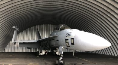 q-model quonset hut hangar with military aircraft inside