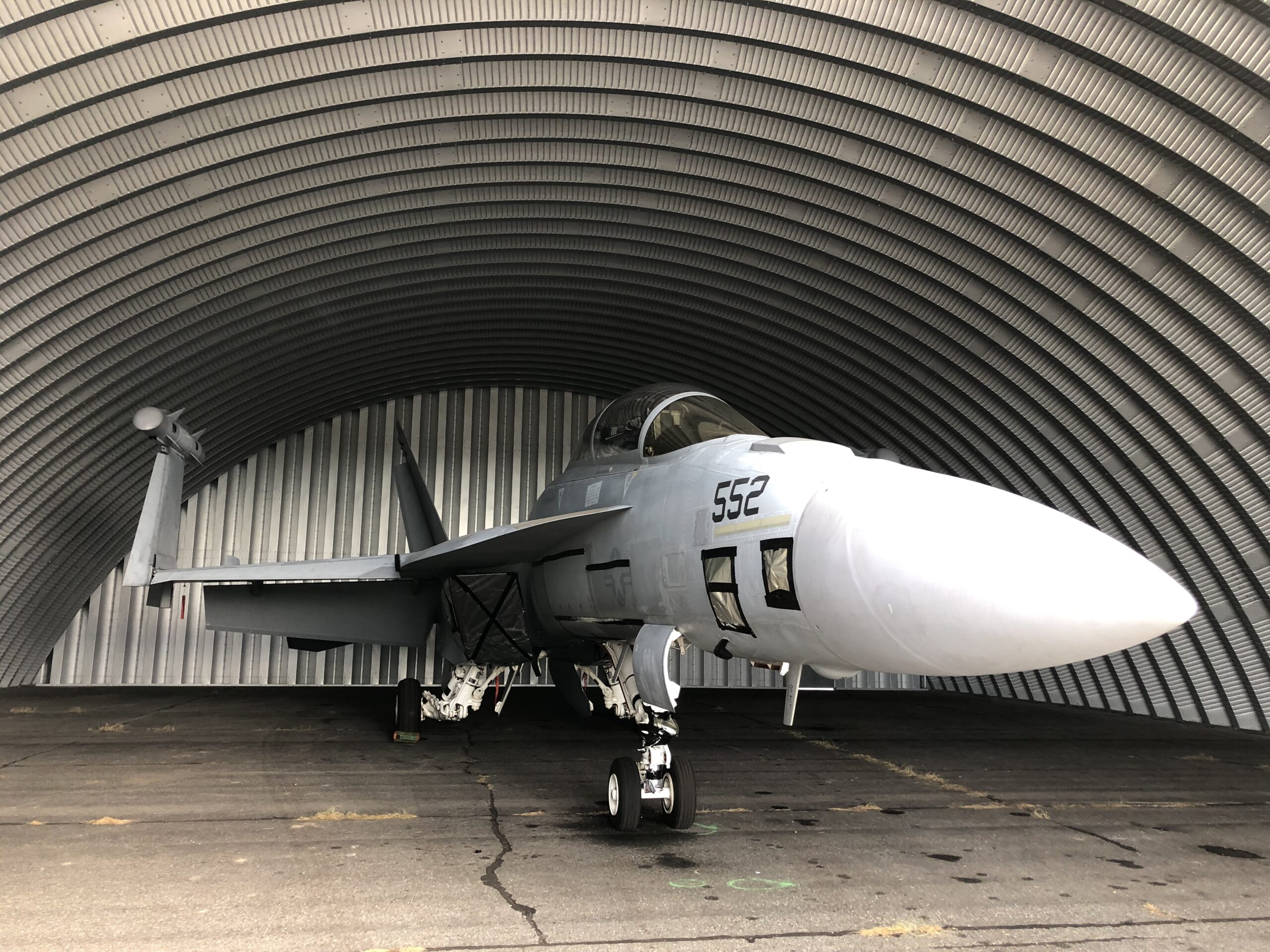 q-model quonset hut hangar with military aircraft inside