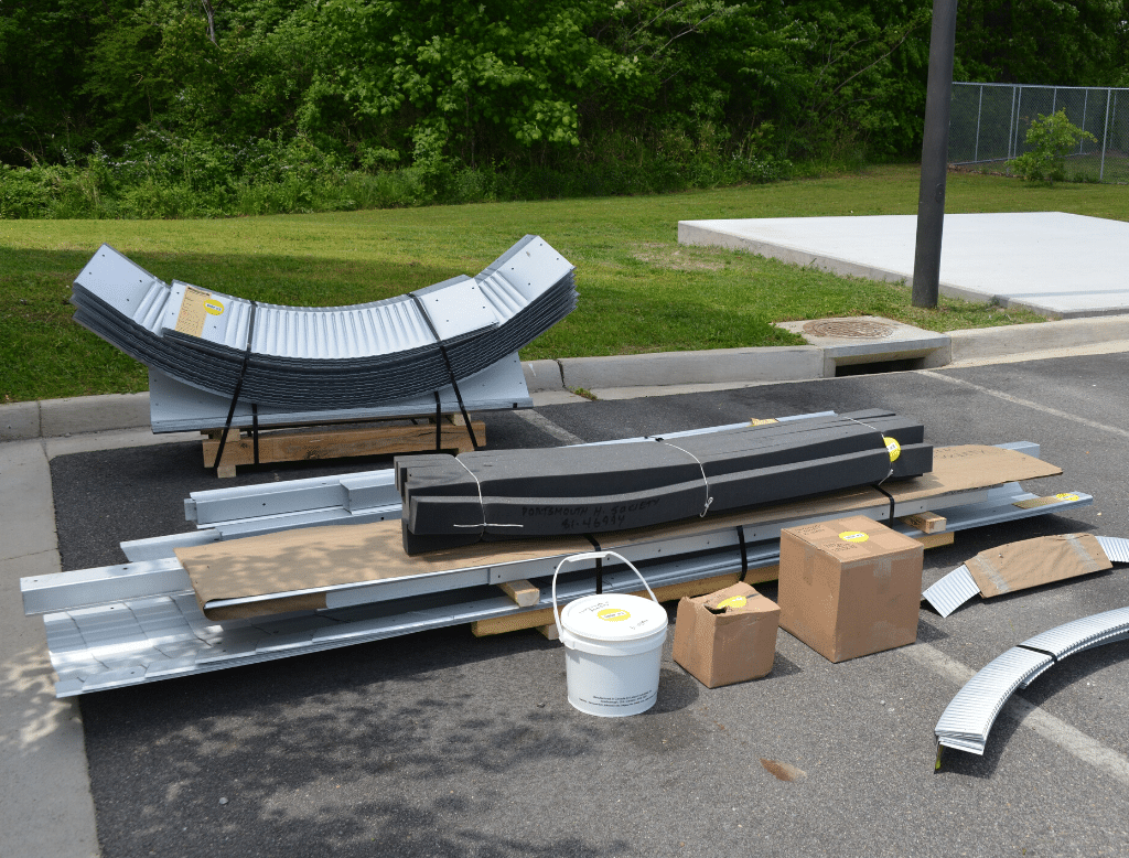 Steel hut building kit and arches in parking lot