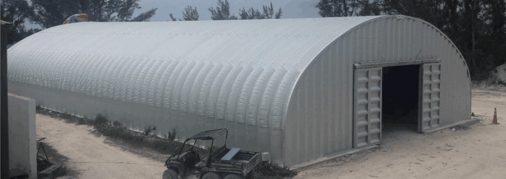 Steel framed Quonset hut storage container Caribbean Gator parked in front sand ground