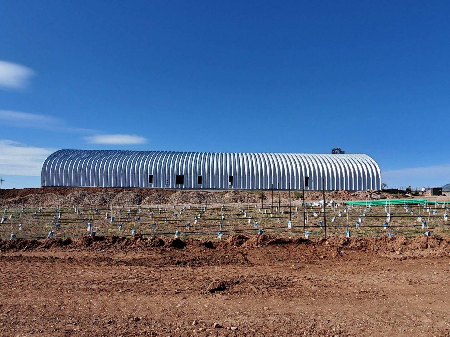 Side view of large steel Quonset
