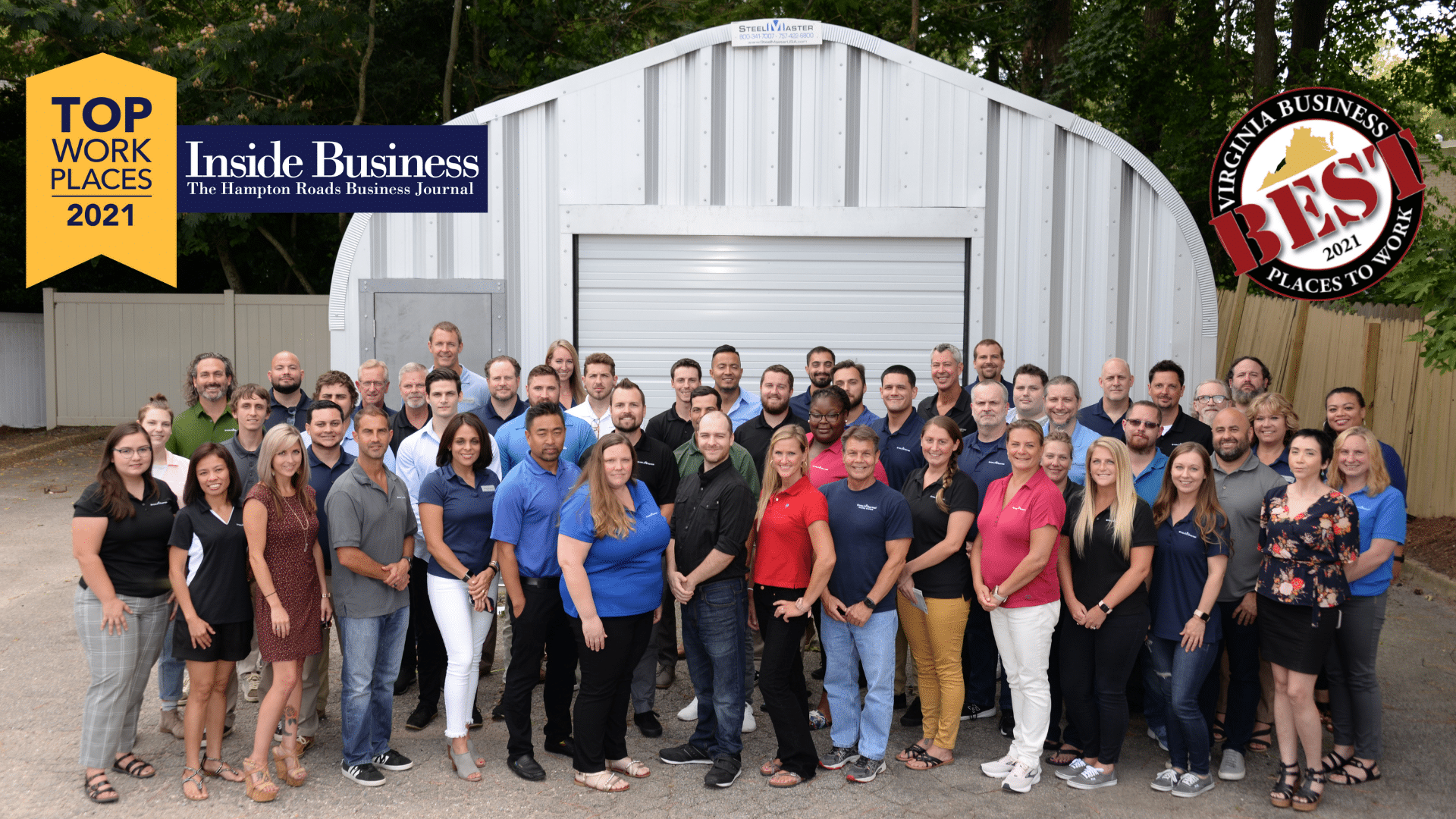 Group of SteelMaster employees standing in front of A-model steel Quonset hut