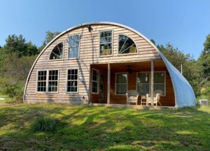 q model quonset building with wooden front end wall, windows, porch