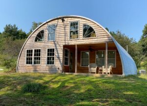 q model quonset building with wooden front end wall, windows, porch