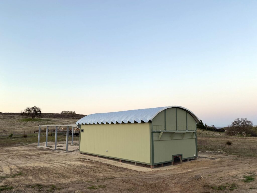 Roofing system on top of custom wooden structure painted green