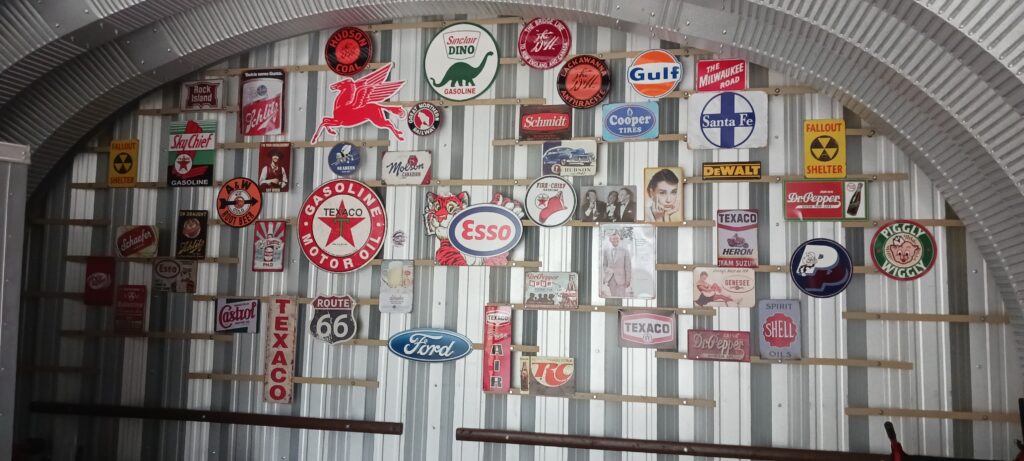 Steel endwall covered in various metal signs