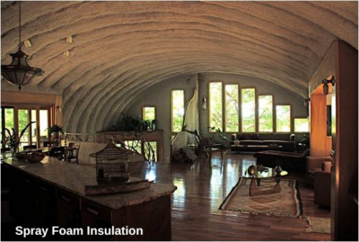 Inside of Quonset home with batten insulation, large windows in front endwall, side entrance, wooden flooring