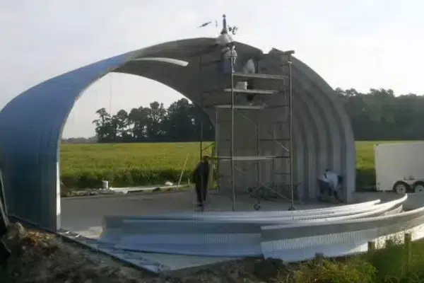 steel s-model quonset hut mid construction with scaffolding