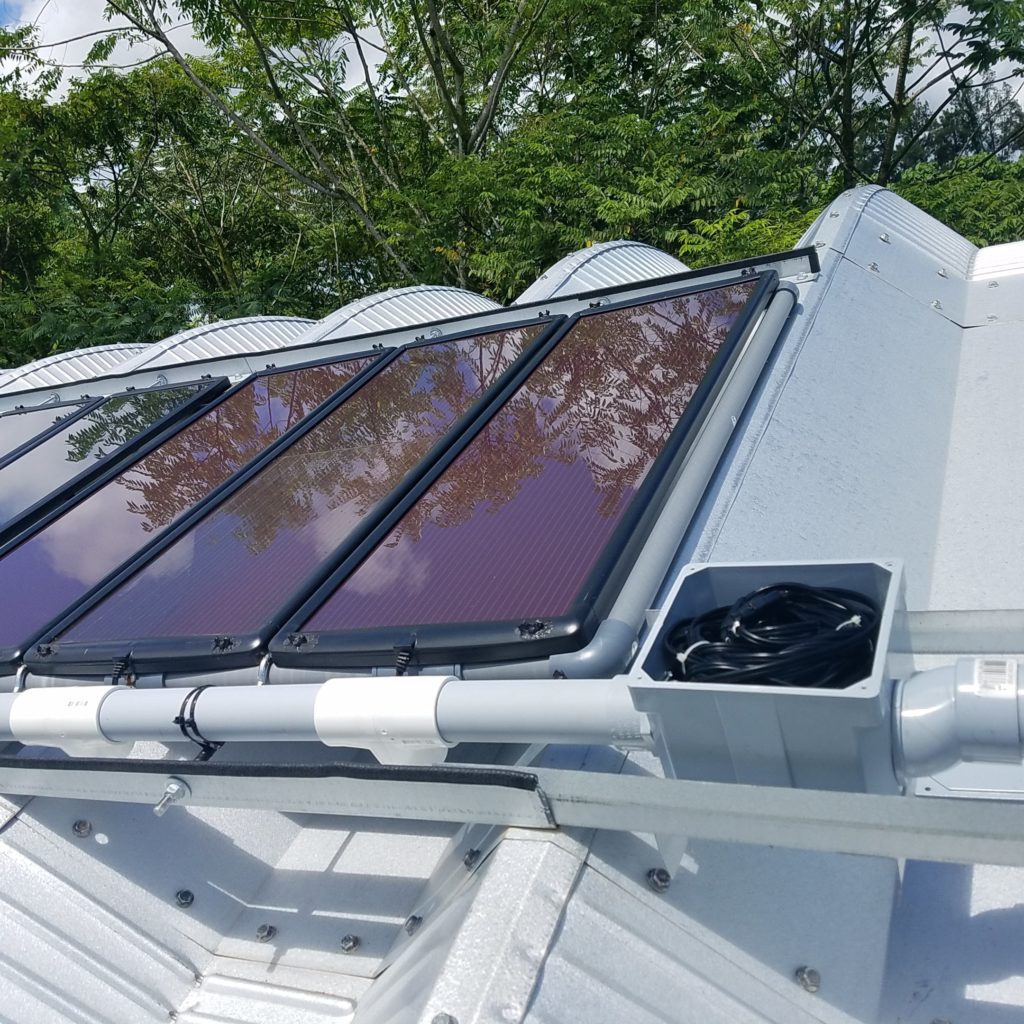 Solar panels mounted on top of a tiny Quonset hut.