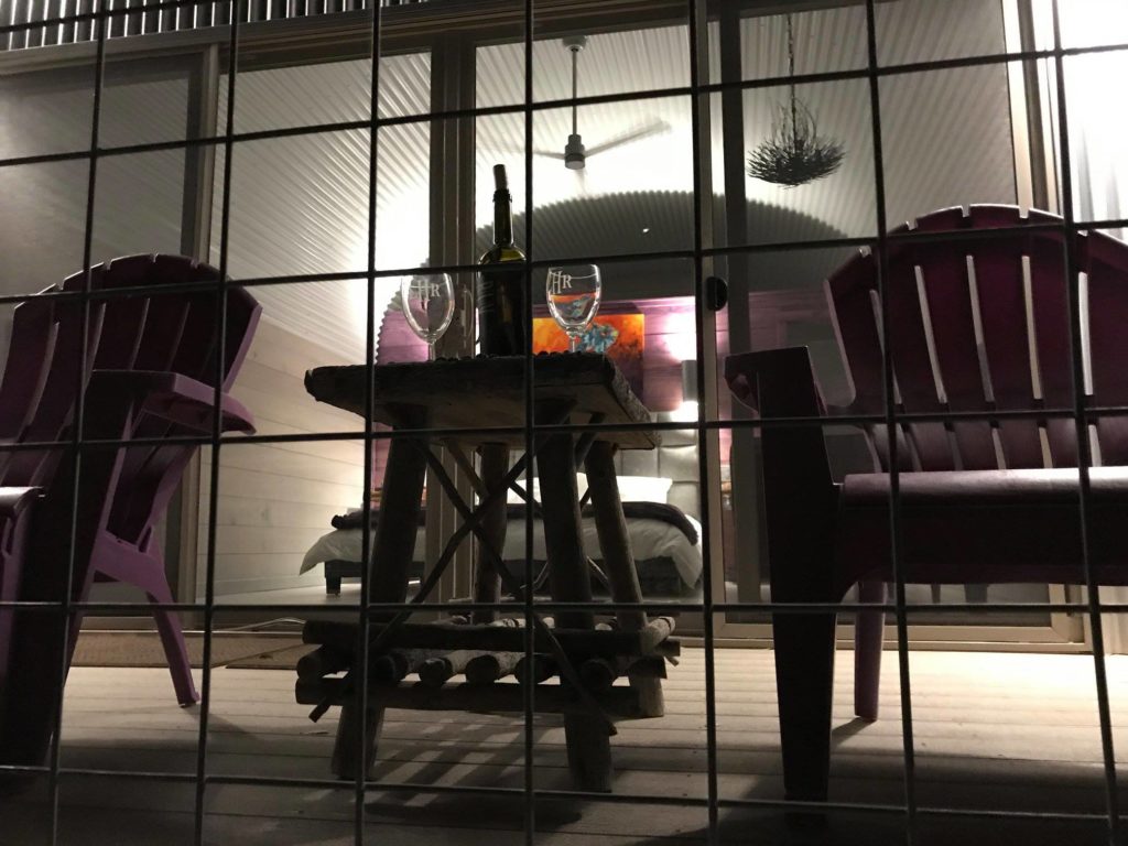 Quonset casita: close up of seating area on terrace looking towards glass doors and bedroom.