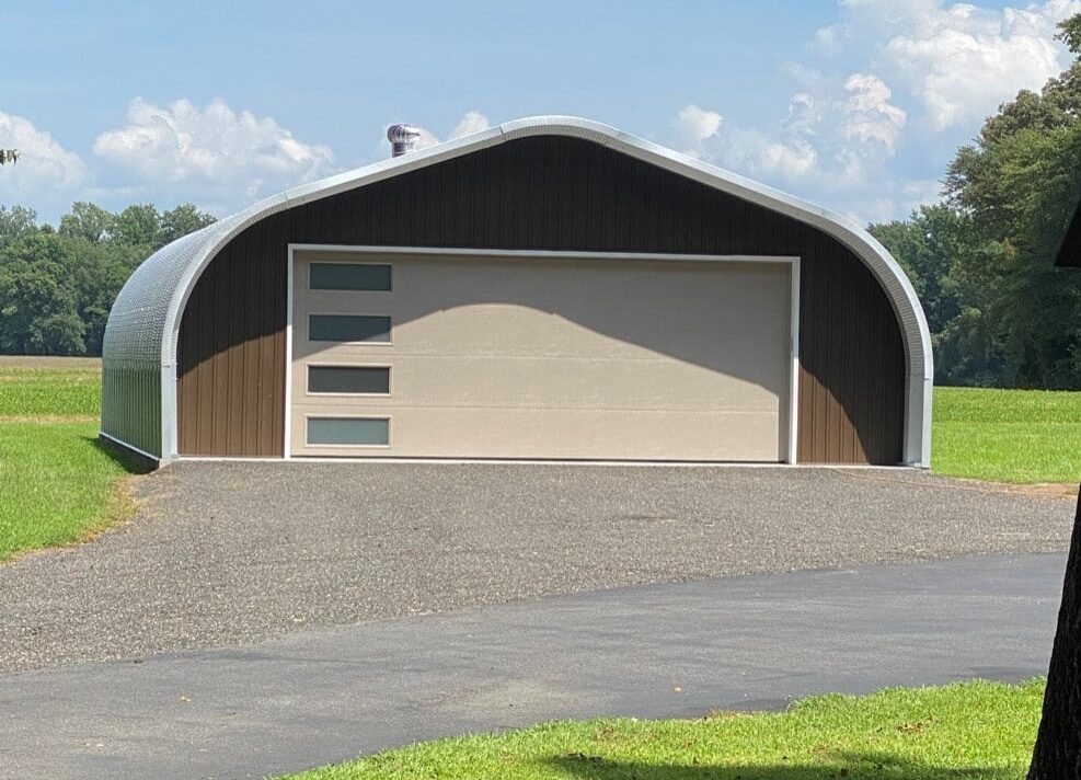 Metal A-model garage with awning above custom endwall and tan garage door