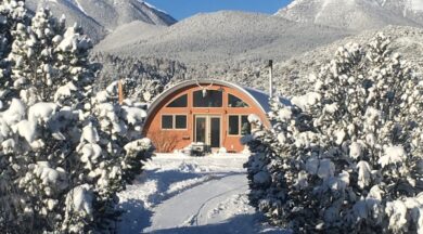 Q-Model house with custom front end wall and custom windows in the snow