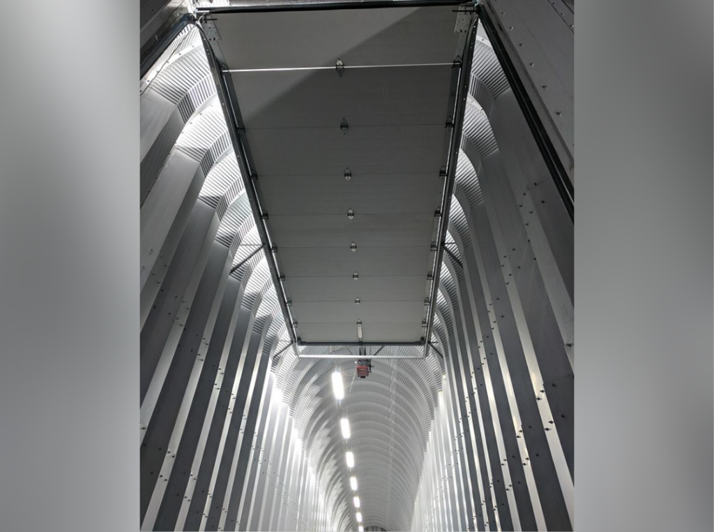 Inside a custom built Quonset hut: automated door in the connecting hallway to close off the main building from the other.