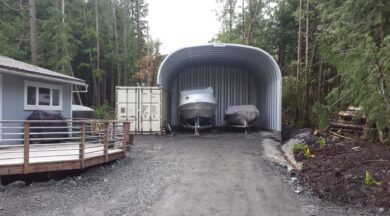 s model steel storage building with steel rear endwall and open front wall with two boats inside
