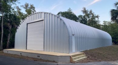 S model athletic facility steel building with steel endwalls and white garage door