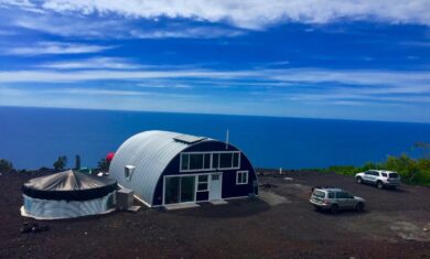 Q-Model house with purple front end wall and custom windows with beautiful ocean in the back