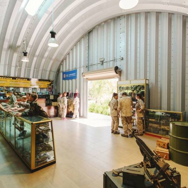 interior view of steel quonset military store with military personnel inside