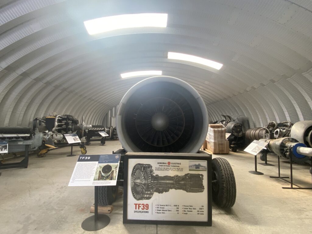 Inside of steel arched museum, metal endwall, aircraft engines, skylights