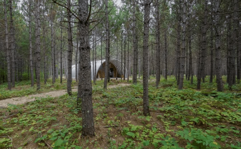 Q-model Quonset Hut with custom cedar endwalls, in the Togo woods, Minnesota.