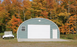 S-Model workshop with teal vinyl front end wall. small window, white garage door, and white entry door