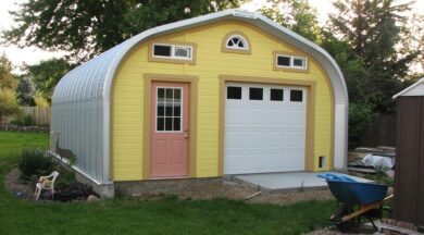 A model shed building with custom yellow front endwall and peach door with white garage door and little windows