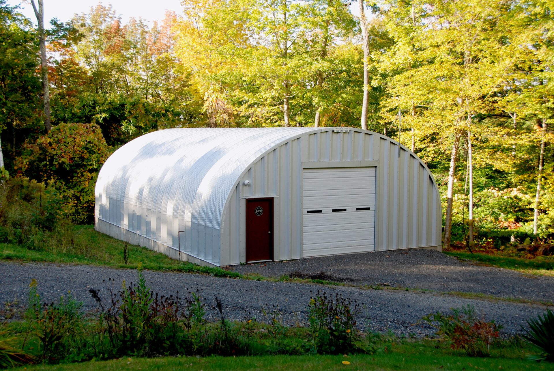 S-Model steel workshop with brown entry door and white garage door